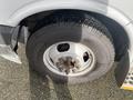 Close-up of the wheel and tire of a 2018 Chevrolet Express showing a steel rim and a rugged tire tread