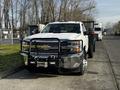 A 2017 Chevrolet Silverado 3500HD with a white exterior and chrome accents featuring a front bull bar and winch