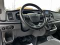 The image shows the interior of a 2020 Ford Transit featuring a steering wheel dashboard and gear shift