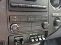 Dashboard controls of a 2011 Ford F-350 SD including climate controls and auxiliary switches