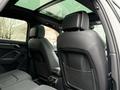 Interior view of a 2024 Audi Q3 showing two black leather rear seats with headrests and storage pockets behind them