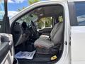 Interior of a 2017 Ford F-550 featuring a driver's seat covered with a patterned seat cover and a steering wheel with controls visible