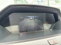 Display screen showing a rearview camera view of a 2014 Honda Odyssey with guidelines and a vehicle in the background