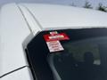 A 2022 Ford Transit with a certificate of approval sticker attached to the windshield displaying months of January through April