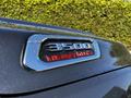 Close-up of the 3500 Heavy Duty badge on a 2022 RAM 3500 truck with water droplets on its surface