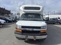 Front view of a 2018 Chevrolet Express with a large hood and prominent grille featuring the Chevrolet logo