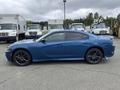 A blue 2022 Dodge Charger parked sideways showcasing its sleek design and sporty wheels