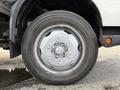 A close-up view of a silver wheel on a 2014 Hino 195 truck featuring a six-bolt pattern and all-season tire with visible tread details