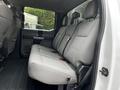 Interior of a 2020 Ford F-350 SD showing a spacious gray cloth back seat with seat belts and headrests
