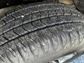 Close-up of a tire with deep tread patterns showing wear and surface dirt on a 2021 Chevrolet Colorado