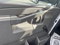 The interior door handle of a 2018 Chevrolet Express with a gray plastic finish and a pull grip design