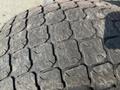 Close-up of a worn tire tread from a 2014 Kubota M7060 showing distinct patterns and grooves typical of heavy equipment tires