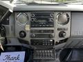 Dashboard and control panel of a 2016 Ford F-550 featuring audio system knobs switches and a keypad for various functions