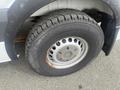 Close-up of a 2009 Dodge Sprinter Van wheel showing a steel rim and a tire with visible tread pattern and some rust around the rim