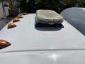 A 2015 Ford F-750 featuring a light bar mounted on the roof and orange clearance lights along the cab