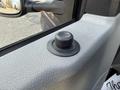 Close-up of the control knob for the side mirror of a 2011 Ford Econoline van