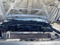 A 2015 Ford F-450 SD with its hood lifted showcasing the engine compartment and various engine components