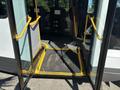 The entrance of a 2017 Chevrolet Express with open doors and a yellow wheelchair ramp extending outward