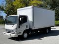 A 2007 GMC W3500 box truck with a white cargo box and front grill featuring a simple design and orange marker lights on the roof