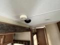 A ceiling vent and smoke detector in a 2013 Outdoor Wind River trailer interior