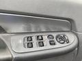 A close-up view of a 2008 Dodge Ram 5500 door control panel showing window switches and a door lock button