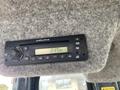 A Delphi radio display mounted on a textured gray surface showing the time as 2:17 PM with various control knobs and buttons