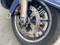 Close-up of the front wheel of a 2017 Harley-Davidson FLHTKL featuring a large disc brake and chrome-accented wheel spokes