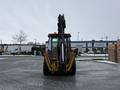 2011 John Deere 310SJ 4x4 Wheel Loader Extended Hoe with a 4 in 1 bucket facing slightly forward from the rear view