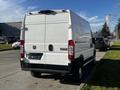 White 2021 RAM Promaster van viewed from the rear with a blank license plate area and the RAM logo displayed on the back doors