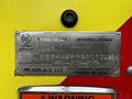 A metal identification plate displaying specifications for a 2009 Spartan Gladiator including VIN and installation date