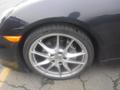 A black 2016 Porsche Boxster featuring a silver five-spoke wheel with a Michelin tire showcasing the brake caliper and vented rotor