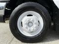 Close-up of a white wheel with a silver rim and a black tire on a 2010 Ford Econoline