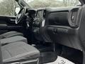 Interior view of a 2021 Chevrolet Silverado 3500HD featuring black upholstery and dashboard controls with a touchscreen display