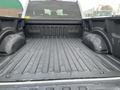 A 2017 Ford F-150 truck bed showing the textured floor and wheel wells without cargo or obstacles