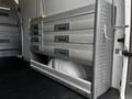 A gray storage unit with multiple drawers is installed in the back of a 2017 Mercedes-Benz Sprinter van