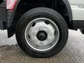 Close-up of a wheel on a 2021 Mitsubishi FE featuring a shiny silver rim with six lug nut openings and a black center cap