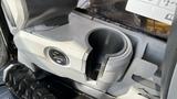 A close-up view of the interior of a 2018 Caterpillar 326F L Excavator showing the cup holder and control panel area