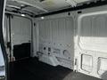 Interior of a 2020 Ford Transit van showing a spacious cargo area with white walls and black rubber flooring