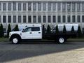 A 2018 Ford F-450 SD with a flatbed design parked along a street