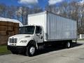 A 2016 Freightliner M2 106 truck with a white box body and single rear wheels parked on a road