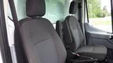 Two front seats of a 2018 Ford Transit shown in a vehicle interior with textured fabric and ergonomic design