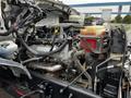Close-up view of the engine compartment of a 2013 Ford F-650 showcasing various engine components and hoses