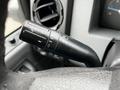 Close-up of a turn signal and headlight control stalk on a 2015 Ford F-550 steering column