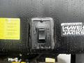A control switch with labels for extend and retract surrounded by raindrops on a black surface