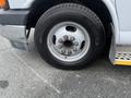 A close-up of a silver wheel on a 2017 Chevrolet Express showing a black Michelin tire with visible lug nuts and a partially flattened appearance