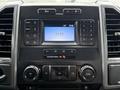 Dashboard of a 2018 Ford F-150 featuring a central touchscreen display and various control buttons for radio media and climate settings