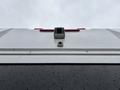 A 2020 Chevrolet Express van viewed from below featuring a rear camera and tail lights with raindrops on the surface