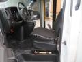 Interior view of a 2020 Chevrolet Express showing the driver's seat and dashboard with controls and a gear lever visible