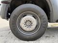 A close-up view of a 2013 Ford F-550 wheel showing the tire with the brand name Arisun and various lug nuts in the center