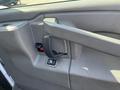Close-up of the door handle and window controls on the interior door panel of a 2016 GMC Savana